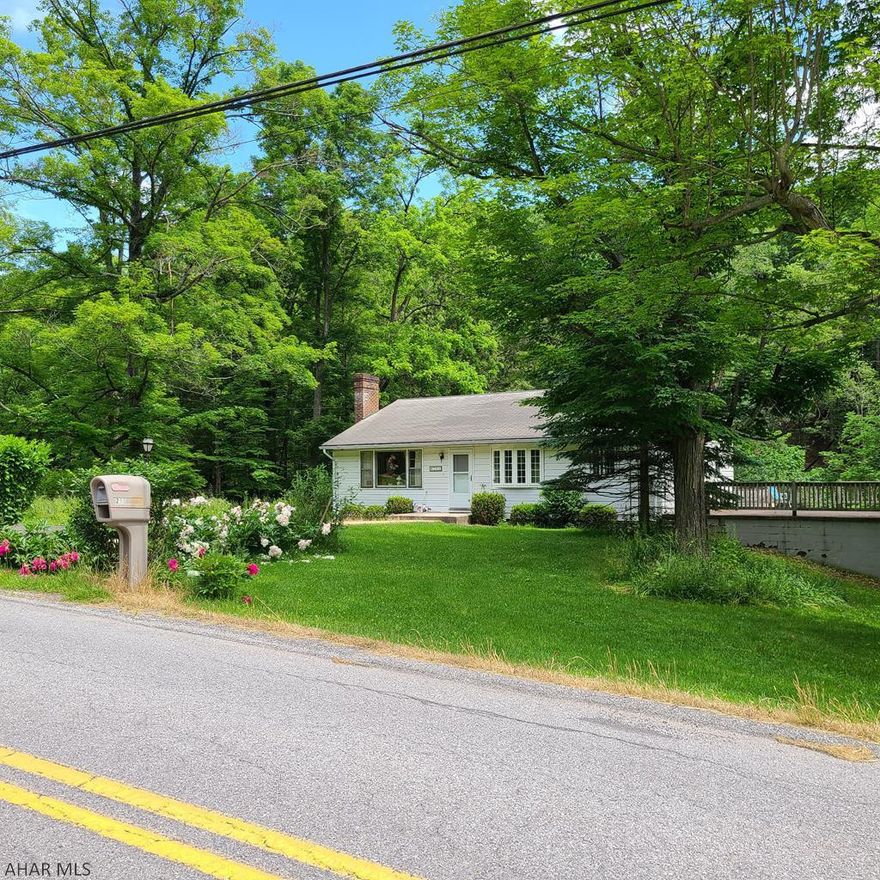 Beautiful country setting on 2.35 acres!  Bellwood Antis School District.  This one-story home needs some TLC, but the lot is very nice and has a flowing stream, an apple tree, peach tree and grape arbor.  The house has some new windows, hot-water heat, hardwood floors, a walk-up attic, a wood burning fireplace, an enormous patio, a long driveway and additional off-street parking.