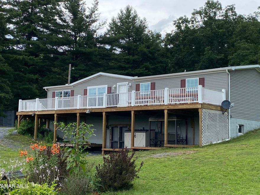 Don't miss this open concept three bedroom two bath double wide with modular frame on a full foundation, central air and ceiling fans offering a unique setting on just over 7.9 acres of  ground.  Primary bedroom features walk-in shower and closet.  There are walk-in closets in each of the other bedrooms. There are two large decks one of which runs the entire length of the front of the home proving an overlook of the majority of the acreage. The full basement is waiting for completion with it's high ceiling height and double doors leading to the outside.  In preparation of completion there is a 100 amp electric box and plumbing for a bath.  Older 4 bay shed on property in need of repairs.  If you want the peace and serenity of country living then you must see this property.    So many possibilities.