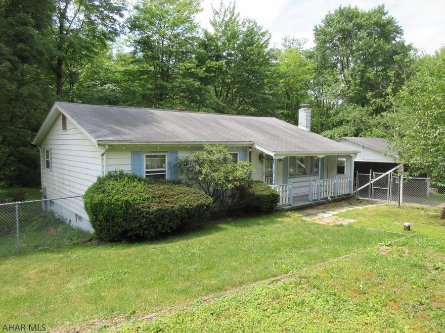 Rare find - Bellwood area ranch home on 2.84 acres! Large living room, eat-in kitchen with dining peninsula and eating area plus 2 nicely sized bedrooms. Finished basement features brick fireplace, bar, laundry room, 1/2 bath and utility room. Large detached over-sized garage with workshop and large attic storage and attached carport. Parking to the front with carport plus wood deck, front porch and rear patio. All on a beautiful, private 2.84 acre lot.