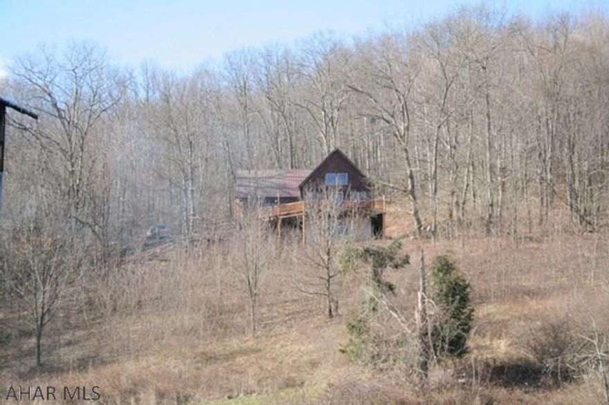 One-of-a-kind home on nearly 67 acres. Lovely views of the mountains from the front deck and absolute privacy all around. Property features two ponds and two large barns with electric. Within minutes of Blue Knob State Park.