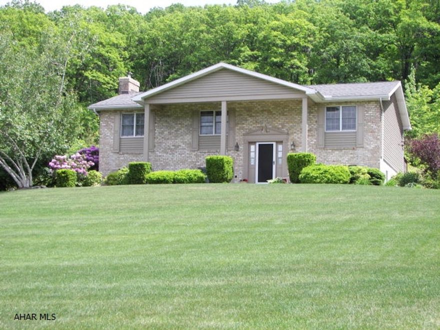 Wildlife,Fruit Trees,Mountain,sprawling lawn with its beautiful landscaping awaits the new buyer of this well constructed low maintenance home with insulated vinyl siding & brick, Andersen Windows, on 13.44 acres of ground. If you are looking to have farm animals or have a place to run your 4 wheeler you can call this home. Stepping into the foyer you can entertain upstairs in the welcoming large Kit. with California Oak Cabinets and SS appliances. The LR & DR with their back drop of Slab Oak blends in perfectly with the outdoor environment. Whether you choose to use the large deck off the dining room to watch the wildlife or cool off under the covered porch you will find it to be quiet & beautiful. The huge family room with its bar and wood burner is great for bringing the family together