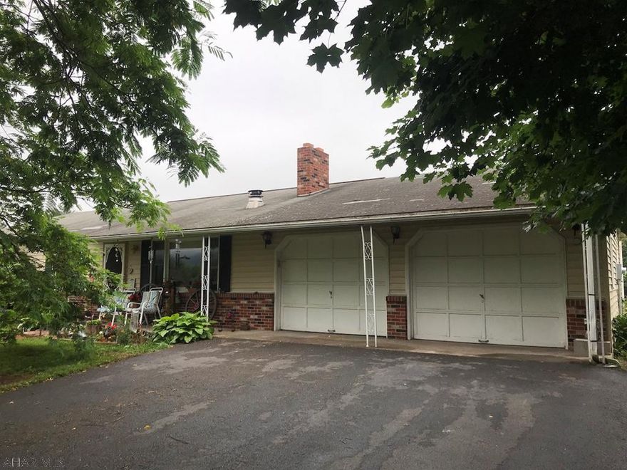 One story living at it's finest with over ten acres of green privacy! 3 bedroom with 2 full baths. Open kitchen and dining area walks out to deck. Deck overlooks beautiful lush flat yard. Basement is expansive and dry with it's own kitchen area. Oversized two car garage with work area, plus a shed. Full mimosa and maple trees camouflage home from road and make it feel secluded and quiet. Convenient location close to Route 70. Property is in Clean and Green program. Set up your showing today!