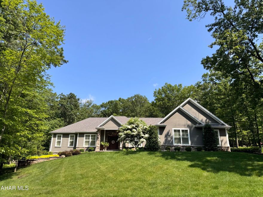 Beyond the stately entryway, discover a residence where every detail whispers luxury and intelligent design. Radiant heat flooring envelops the entire home with separate zones, each labeled for your convenience. There is an expansive two-bay garage, complete with heat and drains for year-round car care and an additional garage bay for additional storage and/or parking. The heart of the home, a chef's kitchen, is a culinary masterpiece featuring polished and leathered granite countertops, a Wolf range, commercial vent hood, farm and prep sinks, and a microwave drawer, complemented by a discreet butler's pantry.
Experience seamless flow with pocket doors throughout and the glow of Restoration Hardware lighting. The property boasts an abundance of natural light throughout the entire main floor. The elegant office, complete with a file room and 3/4 bath, offers private patio access. Grill all summer with a convenient gas hook-up and cozy up by the outdoor gas fireplace. Two guest bedrooms boast generous walk-in closets, while the oversized laundry room provides ultimate convenience. The master suite is a sanctuary, highlighted by a spa-like bath with a soaking tub featuring a freestanding faucet, marble flooring, and an intimate walk-in shower. The bedroom itself features a gorgeous tray ceiling, along with a serene sitting area, a captivating divider wall, and large windows leading to the patio.
Entertain effortlessly in the fantastic open-air sunroom, where stamped concrete extends to the expansive back patio. The stunning outdoor living spaces were expertly crafted by Tussey Mountain's renowned landscaping, adding an unparalleled touch of elegance. A full basement awaits your vision, boasting 9-foot ceilings, pre-installed plumbing for a bathroom and kitchen, a dedicated electrical panel, radiant heat flooring, and a 36-inch doorway for easy access. This exceptional home, meticulously crafted by Joe Crossman, represents the pinnacle of refined living.