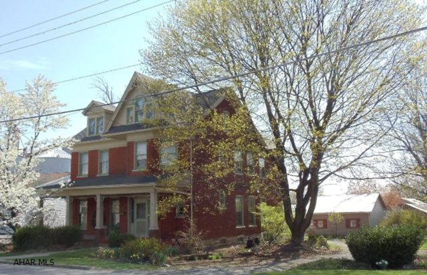 Beautiful 2-story brick home, hardwood floors, pocket doors, family room, 2 Interior Staircases, 1st floor bath w/jacuzzu tub, enclosed side porch, newer furnace, 4-room workshop, & 2-car detached garage.  #J-124