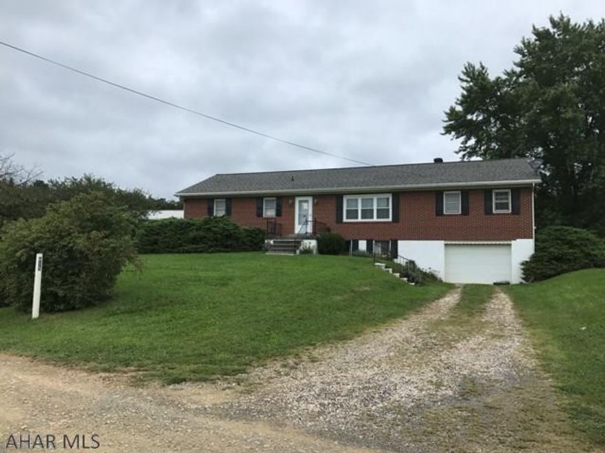 Brick home on almost 1 acre.  Views that are stunning.  Four bedrooms, large rooms, finished basement with a kitchen, family room, bedroom and 3/4 bath.  One car integral garage and a 40x60 detached garage with separate 100 amp electric service, lighting and welding hook up.