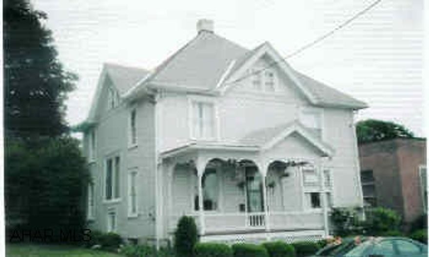 Lovely two story home, with a very pleasant in-town location.two 2-car detached garages with electric, rear deck, front porch. Professional landscaping, hardwood floors, trim taken back to original oak, 4 nice size bedrooms, full bath on each level.