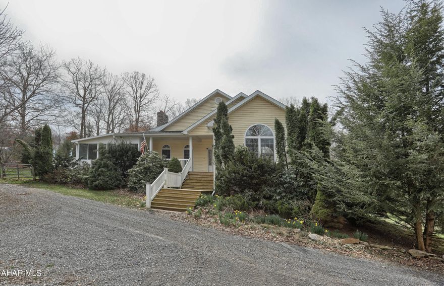 Discover tranquility in this private 4-bed, 2.5-bath retreat nestled in the valley, just 30 minutes from Lake Raystown. Experience year-round comfort with a whole-house generator and outdoor wood furnace. Immerse yourself in custom hardwood floors and cabinetry, illuminated by skylights. Relish the beauty of a 4-season sunroom, and delight in the bounty of 2 orchards. Your secluded haven awaits. This sanctuary also boasts a detached 2-car garage, providing secure parking. Unleash the income potential with an additional structure and revel in ample storage, accommodating both boats and RVs. This property seamlessly combines tranquility with practicality, offering a haven for both relaxation and functionality. All at the end of a 500' driveway, Experience a peaceful oasis, where the journey to your haven becomes a part of the tranquil escape.
