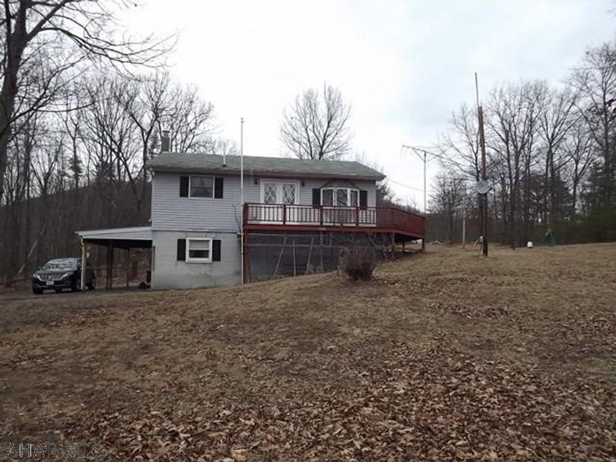 Two floors of living, each with a kitchen. Private 11 wooded acres. Combo heating, open floor plan, built in 1990 and almost 1800 sqft! Close to Maryland border.