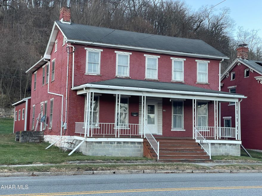 two story 5 bedroom 3 bath Brick home. . detached heated 24x24 garage.  large kitchen with oak cabinets, one full bath on first floor, first floor laundry, two stairways to second story. Fireplace in living room was paneled over years ago.