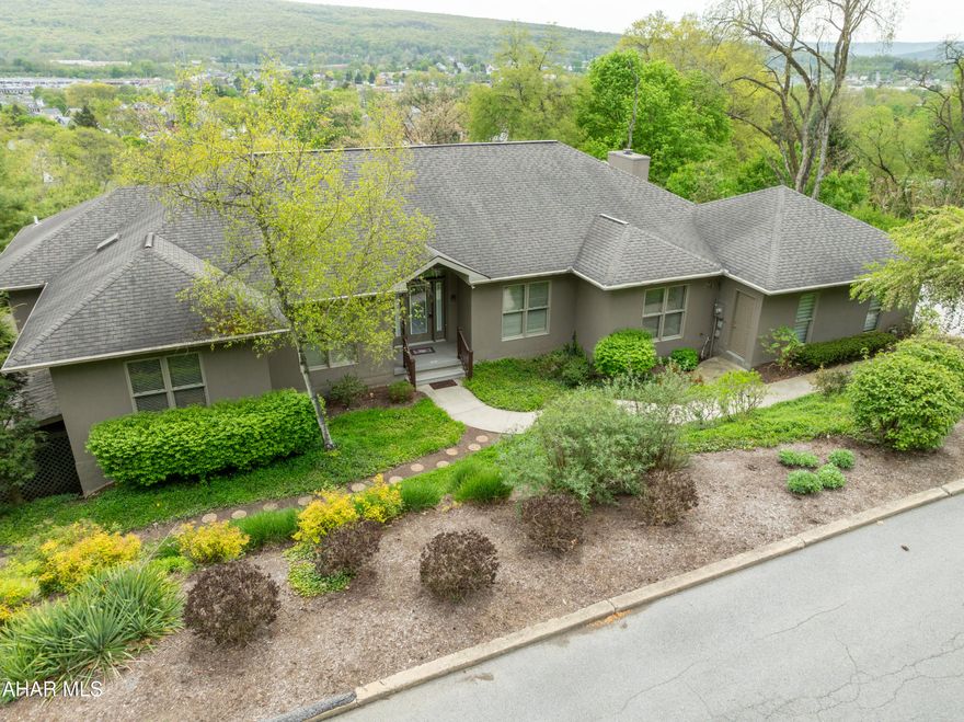 Step into this open concept one story ready for your personal touches.  Spectacular views of the Pleasant Valley area and majestic mountains.  Kitchen is fully equipped.  Spacious living room with fireplace, family room off kitchen and formal dining room. 
 Large deck for family gatherings and parties accessed from owner's bedroom, living room and family room.  Owners' suite features skylight, separate dressing room.  Bath features walk in shower remodeled in 2023.  Main floor has an office and laundry room.  The lower level is finished with a kitchen, open living area with full bath, laundry room, wood burner, private entrance and separate garage space.  Beautiful deck and patio.  South side driveway is heated.