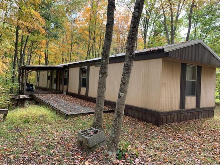 Hunters Paradise on 56+ acres of wooded land!  Abundance of wildlife, deer, turkey, and bear!  14x70 1985 trailer offers a battery powered electric, septic holding tank and is heated with propane. New laminate floor was installed in part of the trailer. Well is hand dug.  Piney Creek year around creek.  Nice tree stand on the property at the top of the property. Seller believes mineral rights convey, a title search will help determine they do.  Their is an Oil and Gas Lease ROW on the property and no gas stored on the property.