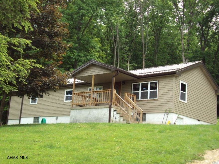 3 Bedroom, 2 bath, double wide with full basement situated on 1.74 acres. Many updated features. Replacement windows, vinyl siding, front porch, metal roof, bathrooms, kitchen, private setting.