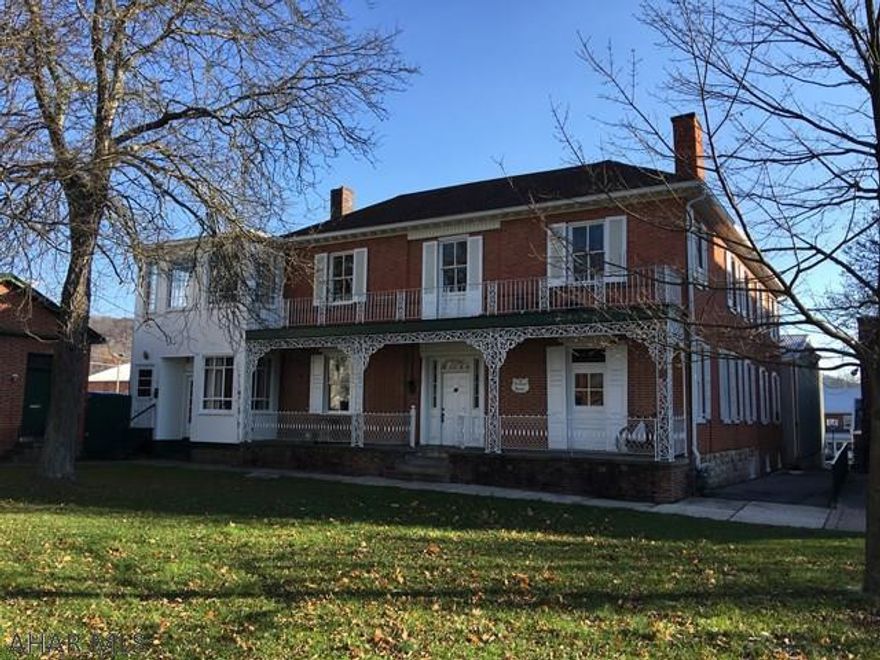 This Prestigious McCauslin Mansion is a  6 Multi-Unit Apt. Complex is within our Historic District.  Each unit is individual and unique, offering history and charm. The decorative veranda and porches adds to the character and history of the McCauslin Mansion built in the1800's.. The exterior trim has been recently painted and the roof was replaced 10 years ago. Located in the town center square with easy walking access to all shops and restaurants.  There is a 30x40 garage adjacent to the apartment building with a 12x20 storage area. Each unit has its own electric box and natural gas is the heat source.
