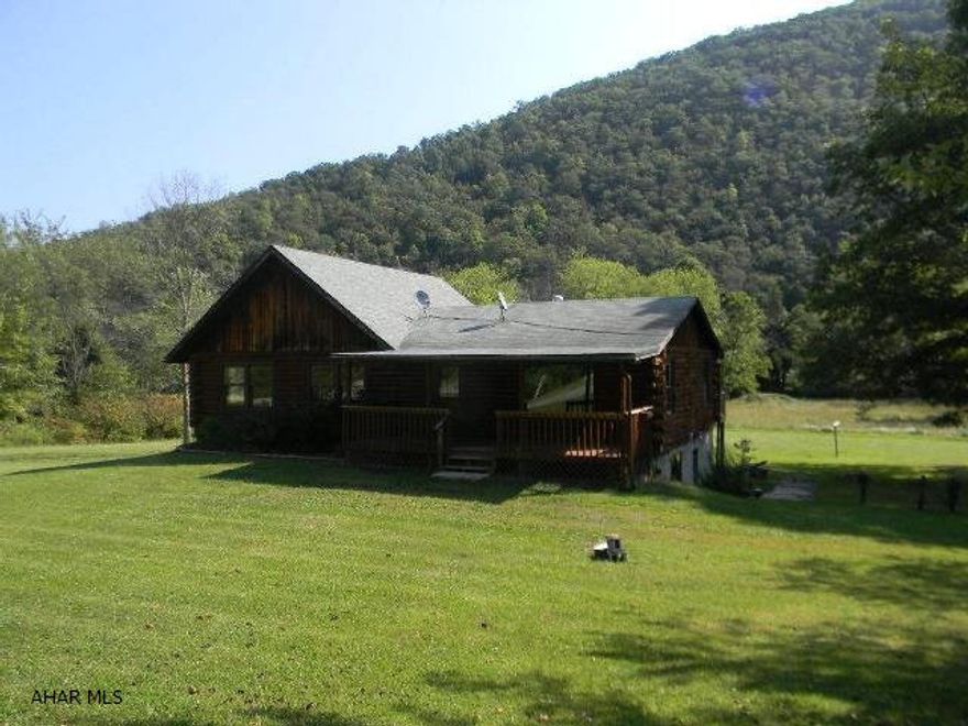 Rustic 3BR/2BA log rancher on large, nearly 2 acre lot with mountain views and access to Juniata River for fishing and boating. Located just minutes from Raystown Lake Resort. This property has flat acreage that boasts plenty of space for boat and RV storage and a finished basement for additional bedroom/living space. Immediately available.