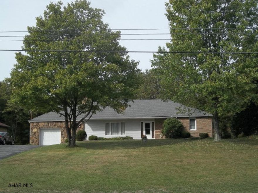 Enjoy rural living in this field-stone ranch home in the Central Cambria School District. Home features large sized rooms with fireplace in the LR. The home has a newly installed Mitsubishi Ductless Heat Pump with Air-Conditioning (2015) and a new 200 amp electric box.  Large back mud room includes washer,dryer,shower,sink and enclosed commode. Newly installed outdoor carpeting on front porch and back patio. Integral garage with storage space between garage and mud room.  Crawl space only; no basement.  There is also an apartment bldg in the back with a two-car garage, kitchen, bathroom and 3 bedrooms. With a little TLC, this apartment could enhance an additional income source or use for personal choice or storage.This home is a must-see and priced to sell! (Total sq.ft per Courthouse)