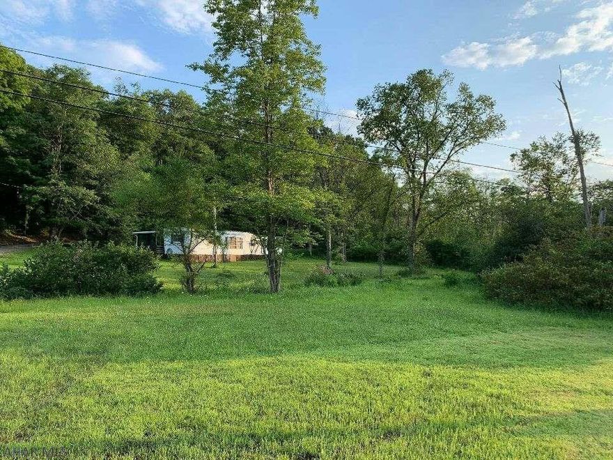 This beautiful property consists of two lots totaling just over 6 acres!  It is conveniently located less than 1 mile from Lake Raystown and the Shy Beaver Entrance/Boat Launch.  The property has electric, private well, sand mound, a stream that runs through the front, large shed and is accessible all year round.  A portion of the land is clear and flat while the rest is wooded.  You can enjoy the best of both worlds!  Also included is a 12ft x 60ft 2 bedroom 1 bathroom mobile home. You can give it some love and bring it to life, or remove it to make room for your own.