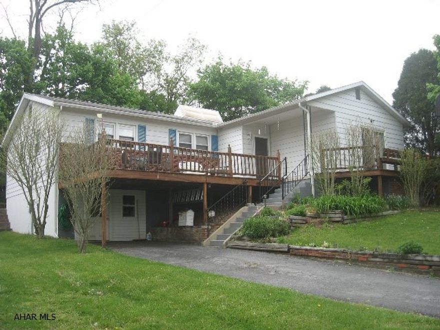 Raised ranch on corner lot in quiet neighborhood! Lots of space & storage.Hardwood floors throughout!Nice landscaping w/shrubs & mature trees,2 decks at front & patio at back with small fenced in yard.Nice LR with sliding doors to front deck;FR has wood fireplace with brick wall,built-in bookcase,ceiling fan.Kitchen w/lots of cabinets,wall of built-ins,eat-in bar area w/stools.1/2 bath off kitchen & MB.MB has wall of closets,hardwood floor & ceiling fan.Two more bedrooms w/nice size closets.Upstairs has hallway linen closet,deep hall closet,pull down attic.Downstairs partially finished;lots of open space;big closet;built-in storage & 3/4 bath.Garage/work shop area with door to driveway.Possible home business?Driveway & along street parking.Motivated-bring offers!