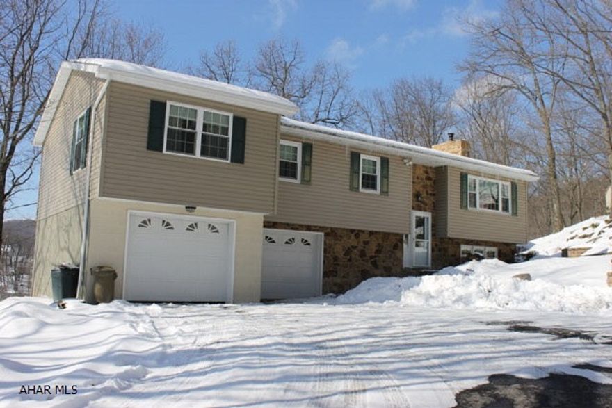 Pride in ownership surrounds this beautifully landscaped home w/ a waterfall in a private setting on 1.8 acres. The very secluded wooded acreage w/ a gazebo that has electric & cable, 2 decks w/ full storage under the one, large shed, & a full size basketball court. Gorgeous family room w/ new carpet, bar & fireplace, 1/2 bath & laundry room on the lower level. As you walk up to the main floor you will find hardwood floors in the living room & dining room, modern kitchen & cheery sunroom w/ a fantastic view as you relax any time of year. Master bedroom w/ a huge walk in closet, full bath w/ double bowl sink & a bonus room that can be an office/den. Two additional bedrooms and two bathrooms on the main level. This MUST SEE property is located in Logan Township.