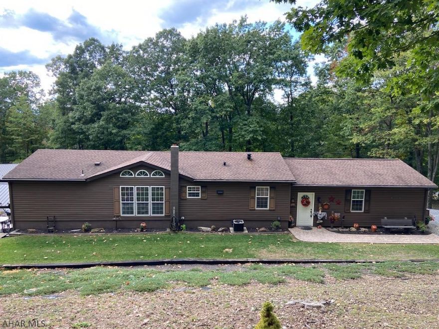 This home is Lovely, Well Kept 3 BR/3 bath home. Lots of privacy adjoins State Game Land. Many enhancements such as recessed lights, oak doors, windows and baseboard trim, 200 amp service along w/ many more upgrades. This home has a full finished foundation and attached 2 car garage. Finished basement w/ family room, bathroom, woodshop/garage leads to a 15x22 pavilion and pool deck/pool adjoining a hot tub deck. Stamped sidewalks lead to an 8x20 front porch w/ underneath storage. This home is heated w/oil F/A along w/a wood/coal furnace, also has central air. Main level has open kitchen, dining room, living room along with 3 large bedrooms, 2 bathrooms, main fl laundry and entry..Has a 12X14 storage shed, as well as 24X30 machine shed. Located few miles from Rt.30, Rt.70, and Pa Turnpike.