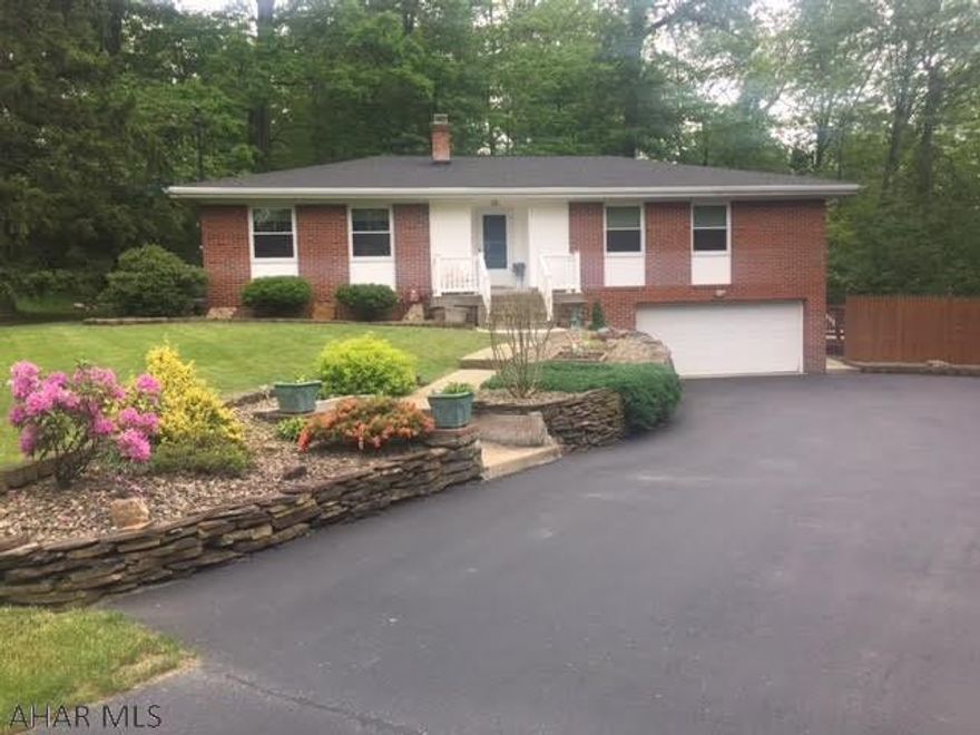 Larger than it looks. This Immaculate well maintained 4 bd 3 bath brick home sits on private setting that is close to shopping and recreation. First floor offers an eat in kitchen with corian countertops, large living room, formal dining room, master bedroom with updated master bath, hardwood floors and replacement windows through out. Basement is fully finished with family room with corner oak gas fireplace, updated 3/4 bath, 4th bedroom and a possible 5th bedroom that is currently used as a gym. Oversized 1 car garage. Sits on a .61 acres. a Large wooden rear deck that extends from the rear of house and wraps around to a hot tub and continues to an above ground pool with large deck. Newer roof and hot water tank. Black topped driveway. C/A. Shed w electrical .