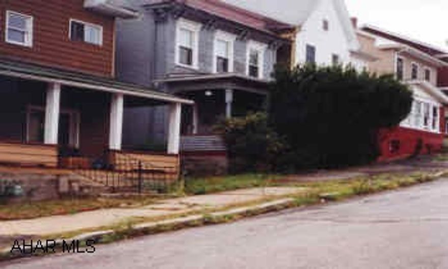 Two story blue house with garage.