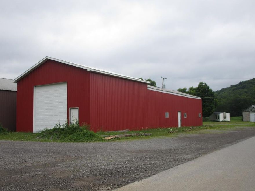 Pole garage on nice level lot. Garage has partial concrete floor. No heat . Being sold as is.