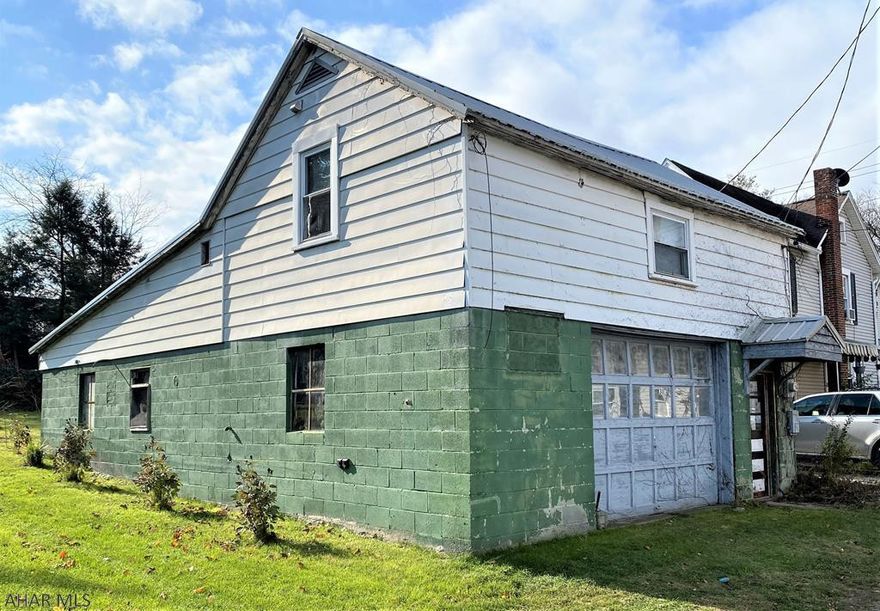 A unique opportunity in Historic downtown Bedford.   1092 sq foot main floor garage to park multiple cars, storage and more.   Second floor is the perfect efficiency apartment with one full bedroom and two 3/4 bathrooms, full kitchen and in-unit laundry.