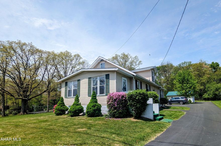 This home sits on over an acre on Brush Mountain Road in Hollidaysburg. Enter into this cute home through the eat-in kitchen; also on the main floor is the dining room, living room, both bedrooms, and bathroom. Detached two car garage plus additional parking outside on the paved driveway. Lovely maple tree in the back yard, shrubs, and a fenced garden space outside, plus some wooded space out back! Inside there's additional living space in the finished attic (not heated) and the enclosed front porch (heated).
