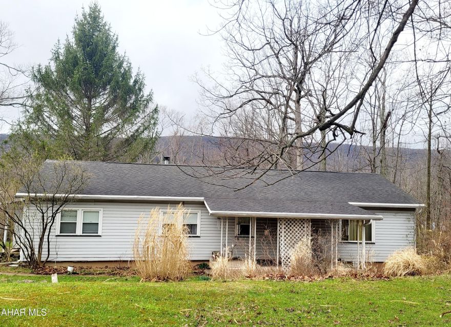 If you are looking to find one story living outside of town, here is your chance to own your own sanctuary in Sinking Valley! Enjoy the beautiful wooded views from the back covered porch. A nice flat yard gives you plenty of room to roam. Inside the house you will find 3 bedrooms, a full bath ensuite in the primary bedroom, a half bath, and easy, accessible living space. This property also has a nice sized shed for storage as well as a very large oversized garage/workshop! The garage has one garage door, but could easily fit FOUR vehicles - or many other possibilities! With a couple of updates to make this house your own, you'll be living with peace and quiet and peace of mind just minutes to all the conveniences of Altoona. Don't wait, schedule your showing today!