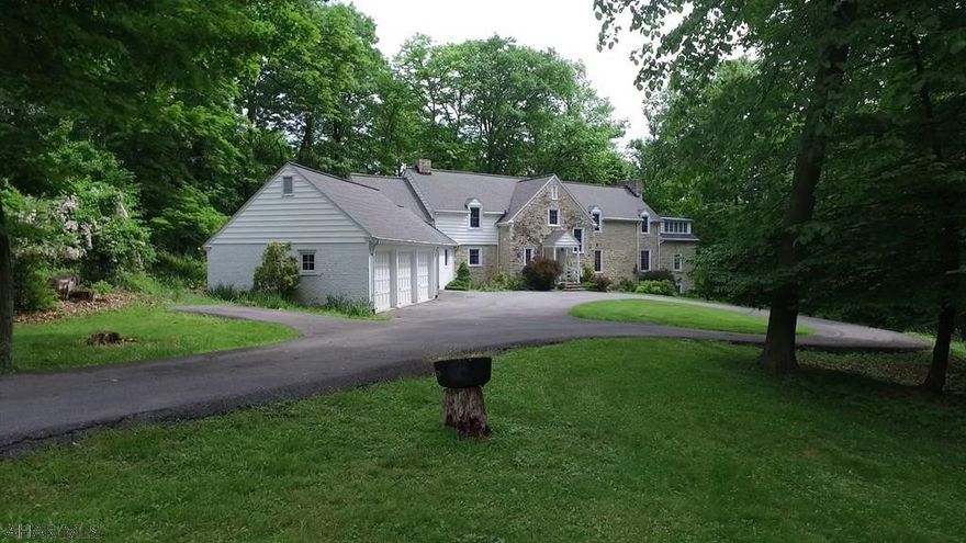 This stunning stone mansion w/ 7.5+/-private acres w/3 car garage is nestled in the woods in one of Bedford's most sought after locations. Hallmark features of this home & stunning views are sure to impress the most discriminating buyer. This Georgian style architecture has been consistently admired for its impressive appeal. Natural gas, extra insulation & energy efficient windows ensure maximum heat savings.  Stately home w/servant's quarter, formal living & dining rooms & kitchen with butler's pantry. 2nd level includes a master wing w/fireplace complete w/master bathroom, dressing and sitting rooms. Another master suite + two additional bedrooms, huge walk in closets are also found on the upper level. .  Adjacent to Omni Bedford Springs. Drone video attached.