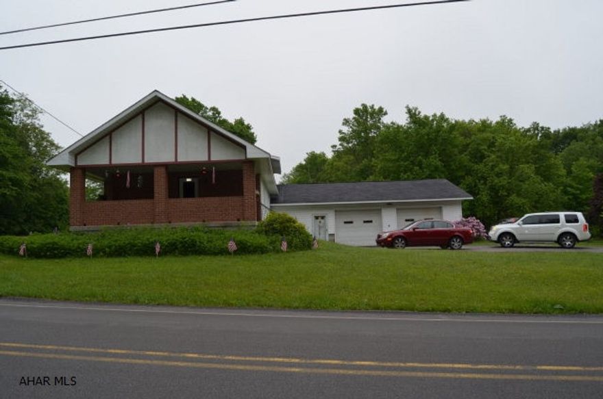 Country home with endless possibilities.This home hes 5 acres of property that is split by 5 deeds. 2.6 acres of the property is across the street which could be sold or used. The house sits on the other 2.5 acres. Huge attached garage with oversized doors and high ceiling. covered front porch and patio. The family room addition has a brick fireplace. Master bedroom has tons of closet space and a powder room.