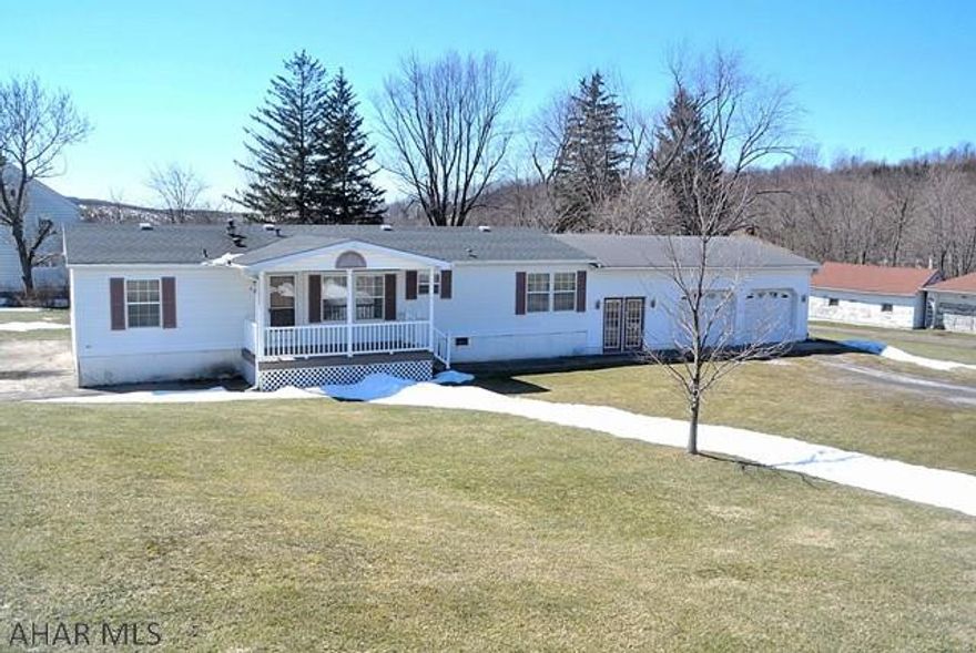 This is a nice one!  This Modern day Doublewide has been already recently renewed.  It just has been given a new roof, some new flooring, New Furnace, new Air conditioner, a water heater, and more.   Also, the township has updated sewer and water lines, and this home owner has already paid the costs of digging, installation of water and sewer lines, the tap on fees,  and its ready to go!!  You can still get financing on this home due to its youthful age.   This home sets on a crawl space foundation while also having a full concrete slab poured for the floor of the crawl space area.  This lovely home also tantalizes you with an enormous oversized 2 car garage.