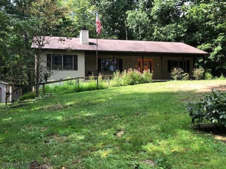 Nestled in the trees is this lovely ranch with master bedroom, master bath on one side, 2 bedrooms and full bath on the other side of this home, with the living room, dining room and kitchen in the middle.  Full unfinished basement with workshop, storage room, and 2 car integral garage.  There is also a 2 car detached garage, a beautiful woodland garden and patio, and a deck across the entire back of the house.