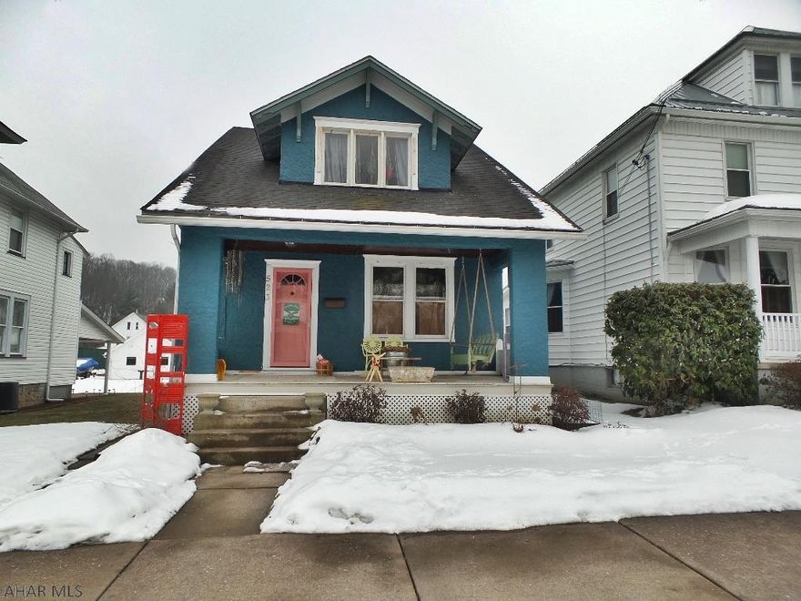 Welcome to this trendy home in a great area of Tyrone!  The windows in this home create a bright and happy atmosphere with an abundance of natural light thru out!  The living room has hardwood flooring and a entry way closet.  It opens to the dining room that has a floor to ceiling antique built-in corner cabinet.  The swank kitchen has open storage and shelving and has new flooring and paint.  An enclosed back porch can easily be transformed into a convenient first floor laundry!  Enjoy organizing with the built-in shelving and storage in the guest bedroom.  The master bedroom offers hardwood flooring and two closets.  The third room creates a huge walk-in closet.  The basement offers a work shop area and don't forget the stone garage.  A large flat lot and convenient location are bonuses