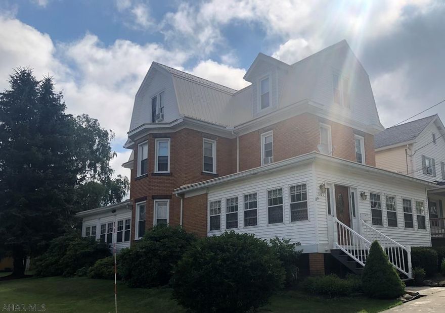 Step inside this magnificent home built in the early1900s. Situated on a corner lot with much character and charm. Kitchen is bright with lots of cabinets, center island and prep sink/wet bar area. New updated 1/2 bath off the kitchen. This home has two staircases leading to the second floor. The living room has a beautiful fireplace with pellet insert. Dining room and parlor have pocket doors separating the two rooms. 6 Bedrooms, 1/2 bath, 3/4 bath and 2 full baths. Upstairs there is a wing that has a large bedroom, smaller bedroom, 3/4 bath with washer and dryer. Also on the second floor two more bedrooms and full bath. The third floor has 3 bedrooms and full bath. New steel roof installed, new landscaping, Large enclosed front and back porches! One car detached garage plus integral gar.