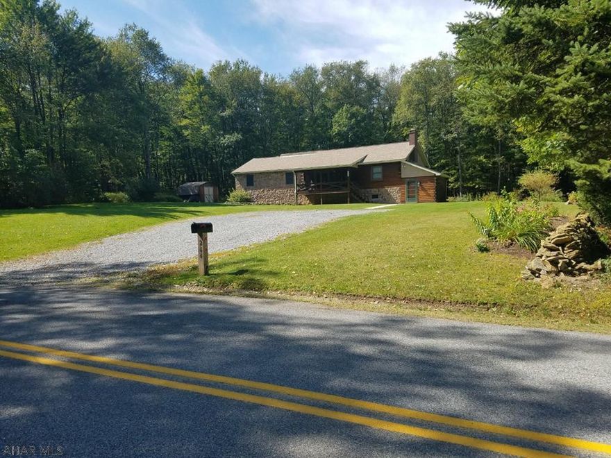 Beautiful log and stone home situated on 2.8 acres for that quiet country setting.  Features include extra large covered deck in the rear of the home and a Vermont Castings coal/wood stove on each level.  Property also has 10x14 log enclosed porch/entry to basement area.