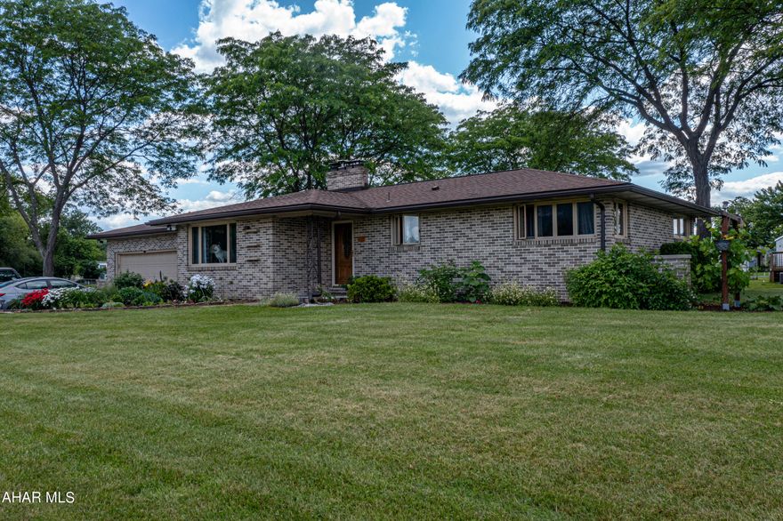 Welcome to this charming single-story brick home, your private oasis! Situated on over an acre of land, this residence boasts 3 bedrooms and 1.5 baths. Highlights include a brick fireplace, 36' gas cooktop, double wall oven, oak hardwood floors, and an open-concept kitchen! The expansive outdoor space is truly a must-see, including a 12X17 shed with electricity! Additionally, the full basement offers the potential for additional living space. The home is also equipped with a central vacuum system, a whole-house humidifier system, a smart garage door opener, premium high efficiency heat pump, high efficiency wood burner insert, and much more!