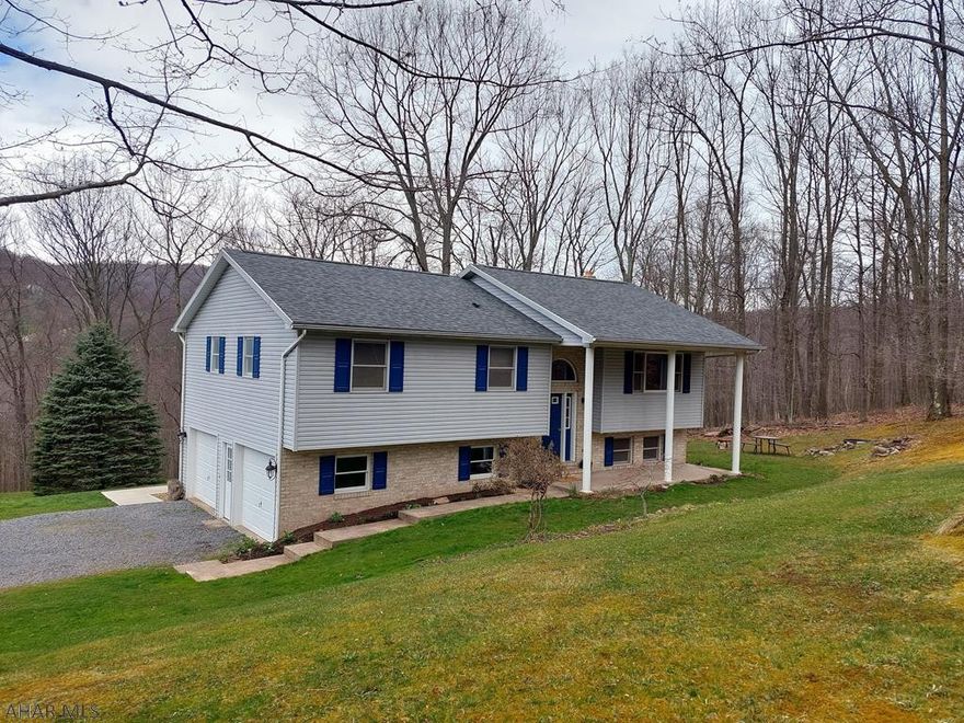 Desirable family home with seclusion in the HASD. This home has an exceptional amount of outdoor space sitting on 1.09 acres, including a 30x40 detached garage with 12 foot doors and another 2 car attached garage. 2 spacious bedrooms with full baths attached to both. Open kitchen to dining room and family room. Walk out onto your deck from your dining room and enjoy the tranquil view of mountains and wildlife. Large family room with wood stove in basement, or use as an additional bedroom. Many updates include sidewalks, appliances, A/C, hot water tank, roof, and more.