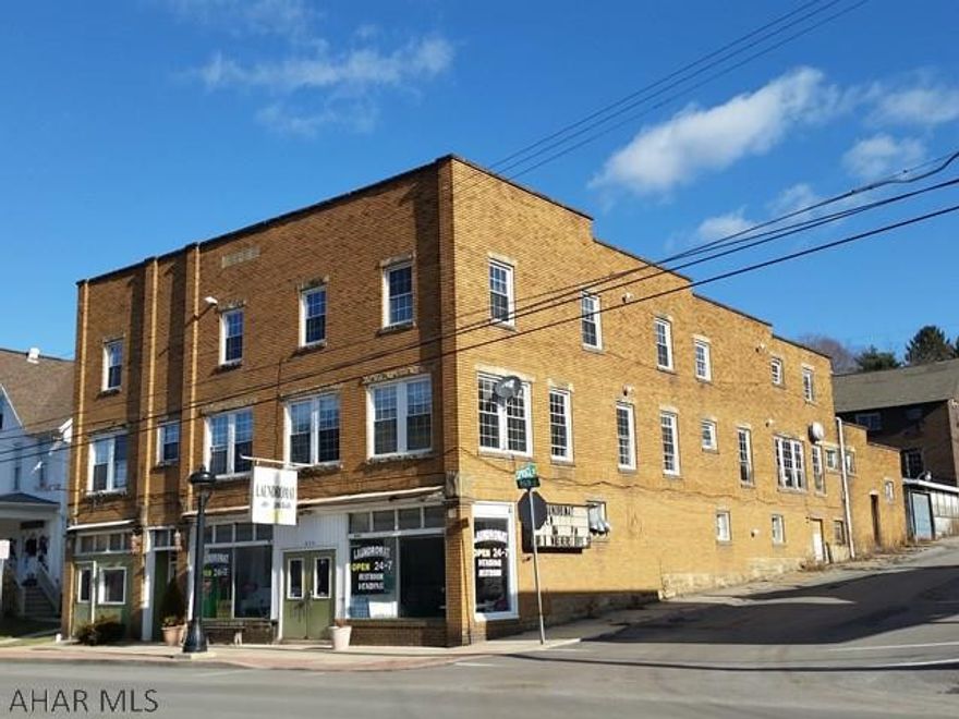 908 Main St Coalport. Many possibilities for this grand old brick building originally the Grenadier Hotel with so much character including: hardwood floors, sandstone cut fireplace and beveled glass and oak wooden doors with possibility of  12 rental units (updated mechanics: roof, windows, 4 furnaces). Plus includes attached garage and a 2 story duplex.  1st floor is a store front with big windows.  Laundry business + laundry equipment not included in sale. SOLD AS IS. J-414.