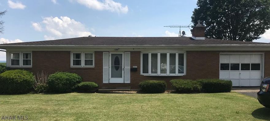 Large Garage/workshop on the back separate heating system unknown if working.Nice 3 bedroom 1  bath with a large eat in kitchen. Hardwood under carpet in house.