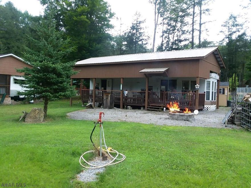 Well maintained 2006 Park Model with slide outs. New 60A service, receptacles and switches will provide you with plenty of power.  Full size appliances, oak cabinets, whole unit stereo, dvd player  Ten gallon water heater can be heated by propane or electric.  Central air conditioning.  Outside enjoy the spacious covered deck.  Large fire ring with stainless steel rack for grilling.  New frostfree hydrant.  8' x 16' shed with lean to for parking your golf cart or quad.  100 gallon leased propane tank.  Dusk to dawn flood lights out back by the shed.  Shale driveway.  Seller will consider financing a portion of the sale.