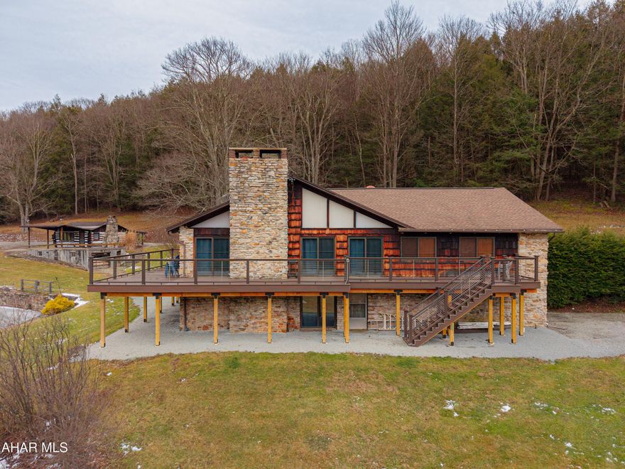 Experience the ultimate private retreat with this stunning contemporary lodge set on 525.26 acres of breathtaking land in Southern Pennsylvania. Designed for comfort, scale, and connection to nature, this exceptional property blends rustic character with modern convenience. Inside, the lodge features seven bedrooms, three full baths, and two half baths, making it ideal for large families, guests, or a corporate retreat setting. The great room showcases a beamed cathedral ceiling with an open layout flowing seamlessly into the kitchen, dining area and loft above with custom made spiral stairvase, creating an airy, light-filled gathering space. Two impressive stone fireplaces add warmth and lodge-style charm throughout. The finished basement is perfect for entertaining or relaxing after a day outdoors. Step outside onto the brand new, expansive, maintenance-free deck and take in the sweeping views of your private acreage, sunsets, flowing waters, and wildlife. The land itself is a rare offering -- over 525 acres featuring a tranquil stream and a picturesque spring-fed lake, delivering unmatched opportunities for recreation, hunting, hiking, fishing, and peaceful seclusion. A truly one-of-a-kind property combining luxury lodge living with lavish natural beauty. Secluded and private yet easy access to major roads, Pittsburgh, Deep Creek Lake MD, Seven Springs & Hidden Valley Resorts, The Omni Bedford Springs, Morgantown WV, Nemacolin, and Ohiopyle. Primed for Year around living; the ultimate get away property; a corporate retreat; destination events; or a super deluxe Airbnb!!