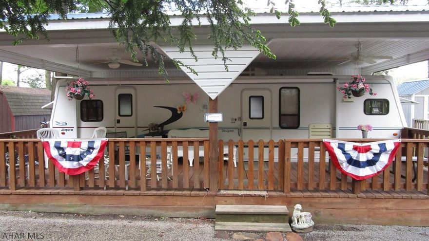 Camper and lot are first class. The kitchen has special order oak cabinetry and a laminate floor.   A queen bed is in the bedroom along with a sleeper sofa and table that breaks down for more sleeping.  Just for the little ones is the clubhouse built for the seller's granddaughter.  The full length covered deck enhances the property by adding outside living space.  Lot is low maintenance.  Shed has a loft for extra storage.  Campsite is located in Glendale Yearound, a gated recreational community adjacent to Prince Gallitzin State Park / Glendale Lake.