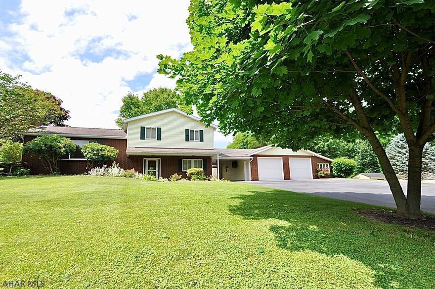 Wow! Beautiful and BIG hillside split level with meandering paved driveway leading you up and into a huge semi attached 2 plus car garage! Quiet country setting in the Village of Warriors Mark; nothing but farmland behind you. 25 minutes to State College or 25 minutes to Altoona. Inside you'll find plenty of room! New oil fired hot water boiler, or heat the home with wood fired outside boiler housed in it's own detached building. Beautiful views all around. Great value see it now and make it yours it will not last.