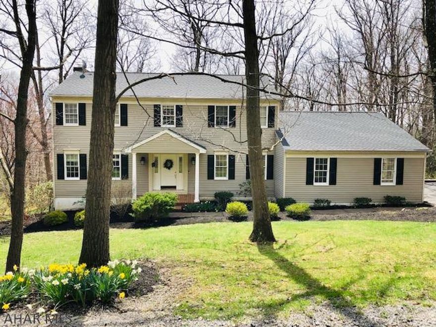 Charming 2 story Colonial in Stonehedge on a large, wooded lot. This beauty features 4 bedrooms, 2.5 baths, large eat-in kitchen, gorgeous hardwood floors, large covered deck, newer carpet, and much more.