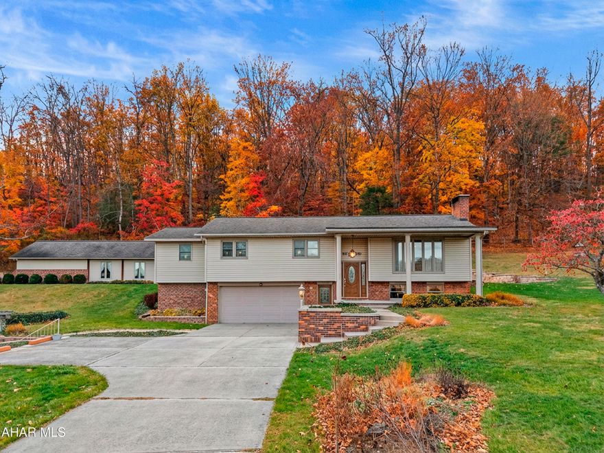 Welcome to this beautifully maintained split-entry vinyl and brick home, perfectly situated on 2.889 scenic acres. Offering exceptional space, comfort, and craftsmanship, the property impresses both inside and out with a thoughtfully designed rear addition, a luxurious primary suite, and numerous quality upgrades throughout.

The main level features a stunning renovated kitchen with ample cabinetry, generous prep space, and all appliances included—ideal for both everyday living and entertaining. Adjacent to the kitchen, the formal living room is highlighted by a sparkling crystal chandelier, illuminated each morning by the sunrise streaming through the large picture window. Spanning the full length of the home, the rear addition is bathed in natural light and offers expansive windows overlooking abundant wildlife and vibrant perennial gardens. An electric fireplace and geothermal floor heating create a warm, inviting retreat in every season. Whole-home surround sound and central air enhance comfort and enjoyment year-round.

The main-level primary suite is a true sanctuary, featuring a spa-inspired bathroom with geothermal heated floors, an oversized jetted tub, and convenient in-suite laundry. Two additional bedrooms, a full bath, and a half bath complete the main level. The finished basement offers a spacious living area centered around a cozy wood stove, along with a kitchenette, half bath, and laundry closet—providing flexible space for relaxation or entertaining.

Outdoor living is equally impressive and designed for year-round enjoyment. A picturesque 75' x 75' pond, ranging from 4 to 10 feet deep, features a lighted fountain, wood and stone decking, and excellent fishing opportunities. Overlooking the pond is a pergola with a large stone fireplace, creating the perfect setting for fireside gatherings on cool evenings or peaceful relaxation during warmer months.

Additional highlights include a two-car attached garage with an adjoining encapsulated heated and cooled storage space, a 20' x 30' pole barn for larger equipment or storage needs, and a 24' x 40' outbuilding offering a workshop, extensive storage, and a root cellar ideal for preserved goods. Beautifully maintained flowerbeds and garden areas enhance the natural beauty of the grounds, while mature fruit trees on the adjacent acreage provide seasonal harvests and contribute to the property's private, pastoral atmosphere.

Select equipment—including multiple mowers, a Bobcat tractor, a low-boy trailer, and a zero-turn mower—is available for purchase, and all home furnishings are negotiable.

Lovingly cared for and rich with cherished memories, this exceptional property is now ready to welcome its next chapter!