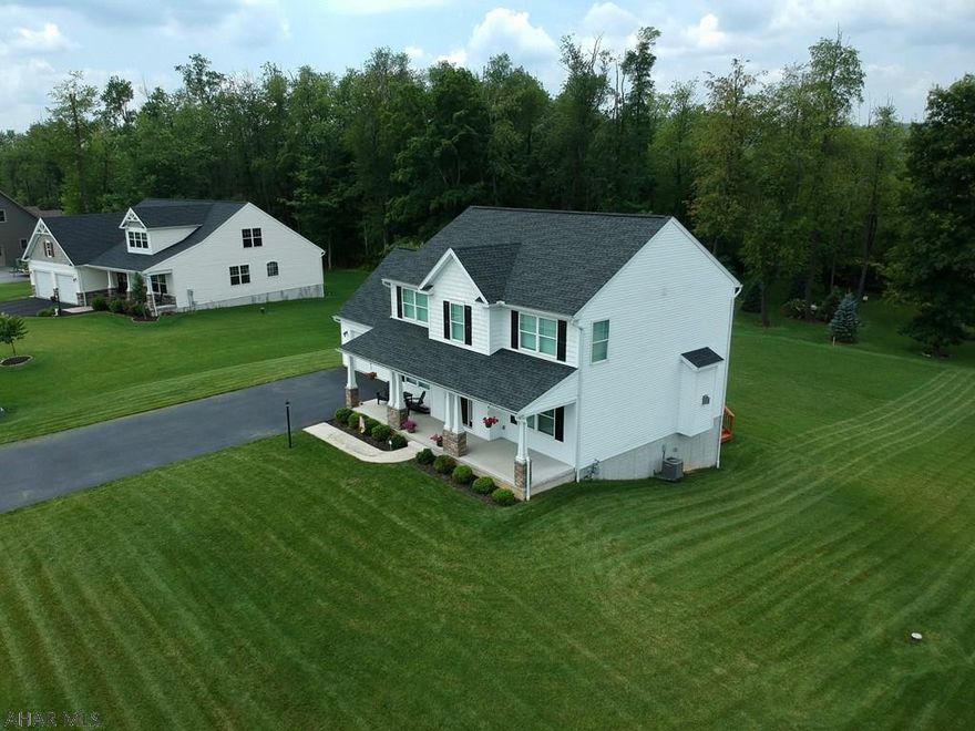 A modern craftsman style home in Rolling Hills North with so much to offer! The main level has a very open floor plan with hardwood floors throughout. The kitchen has plenty of cabinet space, included appliances, as well as access to the rear deck - complete with a retractable awning. There is also a formal dining room, living room with natural gas fireplace, half bath and bonus room all on the main floor. The second floor has four large bedrooms plus two full bathrooms. The master bedroom has an en suite bath and a large walk-in closet.  This amazing home also has a full unfinished basement, a two car garage, new carpet, security system, and is situated on a large (over half acre) corner lot!!  Be sure to check out the 3D tour!!