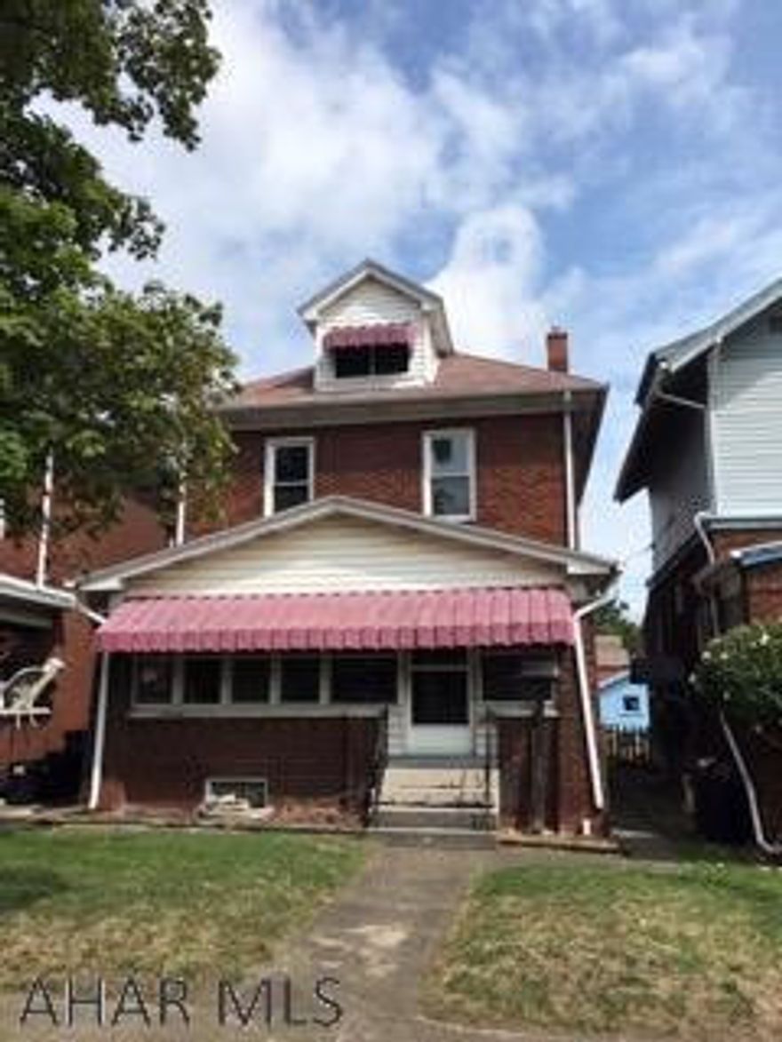 PERFECT FOR RENOVATION LOAN!!!!!   This solid brick 3BR 1BA has much potential.  It NEEDS A KITCHEN AND BATH  but offers nice sized rooms and an extra enclosed front porch and a fenced yard w/ 2 car detached garage.  Great original woodwork throughout the home. 2nd floor has thermo windows. Could be a great 1st time home w/ a reno loan. Seller will make no repairs. Definitely worth a look!  Please look past all of the personal property to see the true potential.