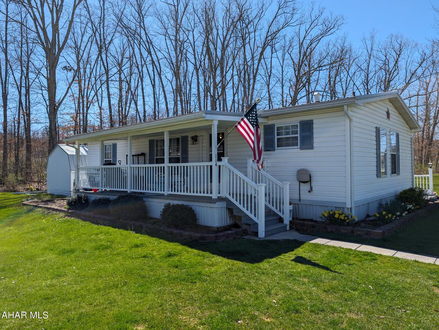 Community living and all of the amenities are here! Located amongst the Allegheny mountains in beautiful Friendship Village, this corner lot, 1990 doublewide has all you need in a 55+ community. Two bedrooms, two full baths, a living room, kitchen, dining room, and laundry area. This home also boasts a large covered front porch for all the summer swinging and porch sitting you desire, and a 3 season room with built-ins. This home has a front door padded lock system, NEW (2024) metal roof with warranty from Kauffman metals, new roof on shed, newer dryer (2023), water heater (2022), and carpet tiles (installed 2022) in bedroom. Home has oil forced air heat or use the newer mini split for heating and cooling. A paved driveway with parking for 4 and mature landscaping. Enjoy living in Friendship Village with all the amenities. $330 lot rent includes garbage. Swimming, miniature golf, convenience store and activities in the village galore will keep you entertained. Make this very desirable and sought after community life yours today!