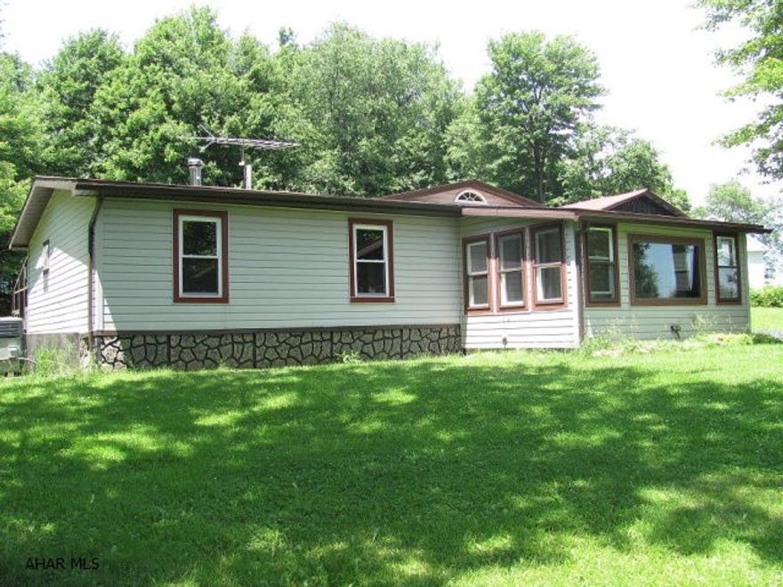 Central Cambria schools- doublewide with additions on 6 acres. 3 car detached garage & familyroom. Florida room with hot tub.